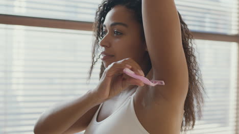 woman shaving her underarm