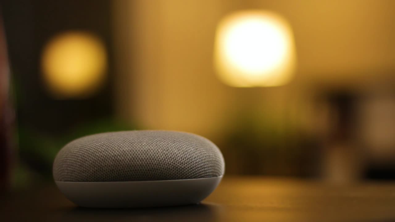 Voice controlled mini speaker turns on a light in a smart home at night