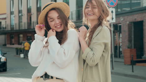 two young women posing on a city street