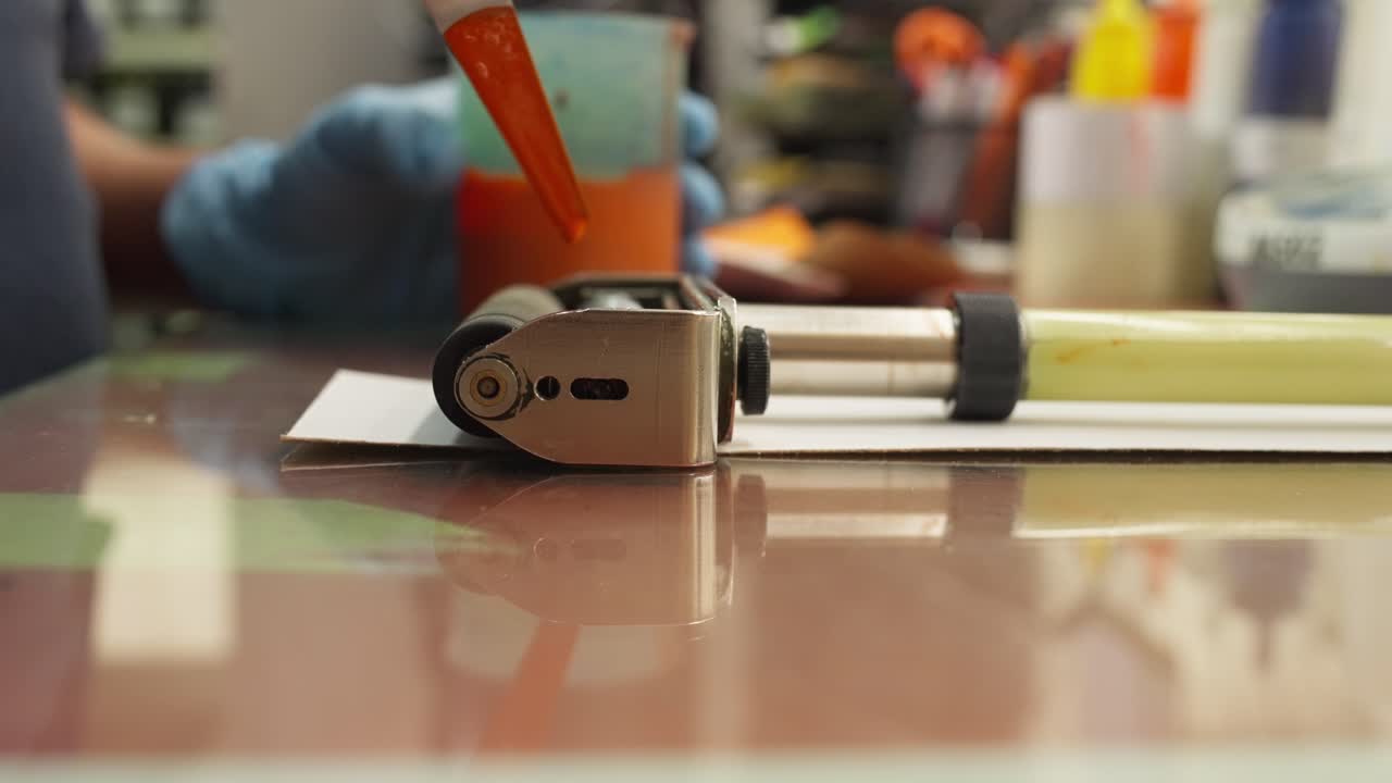CLOSE UP SLOW MOTION SHOT OF AN INK TEST AT A INK WORKSHOP