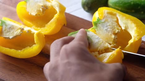 cutting yellow bell peppers for cooking