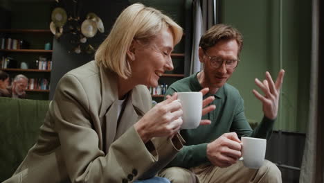 man and woman having a casual conversation with coffee