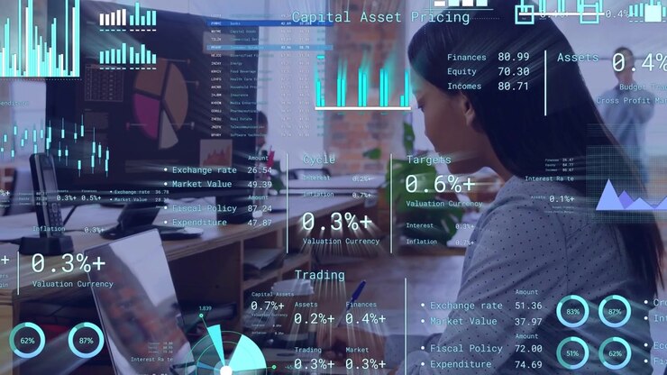 Woman analyzing finance dashboard in open office, tapping trackpad, updating HUD metrics for report