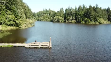 sitting on a dock while flying a drone over cullaby lake, oregon