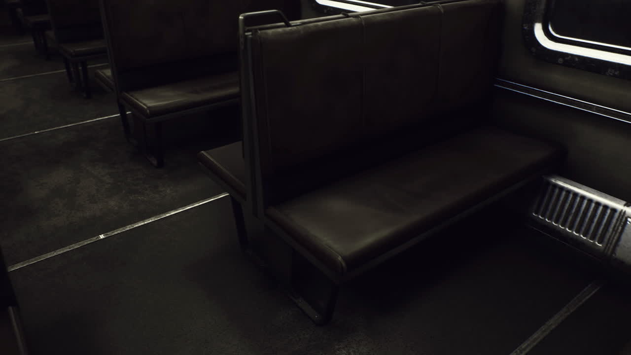 Empty subway car interior reveals worn seats and dim lighting in urban setting
