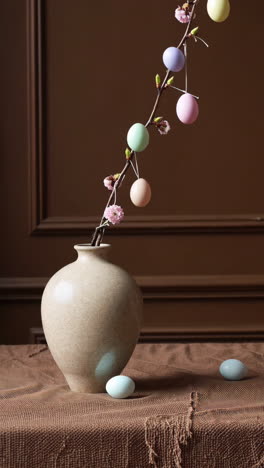 pastel easter eggs decoration with branch in vase