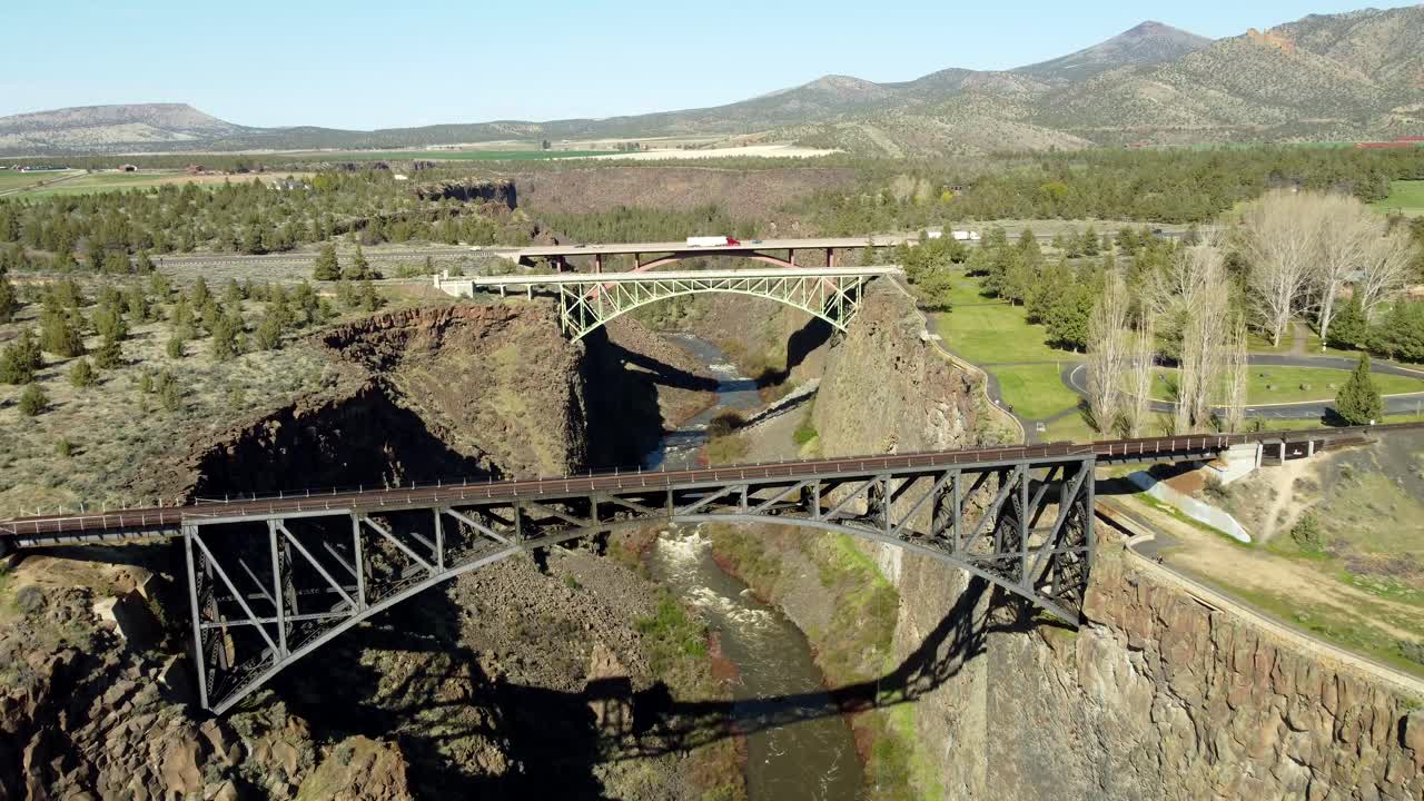 US, Oregon, Redmond, Crooked River High Bridge, 2025-04-12 - Drone view of the railroad bridge, pedestrian bridge, and road bridge over the Crooked River at Highway 26 in spring in central Oregon