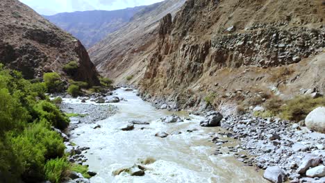 aerial rising shot over the river of colca canyon between mountains peru