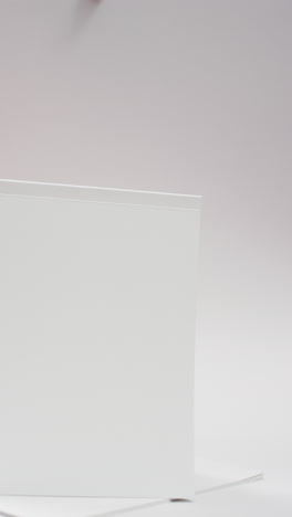 vertical video of book with white blank pages and copy space on white background