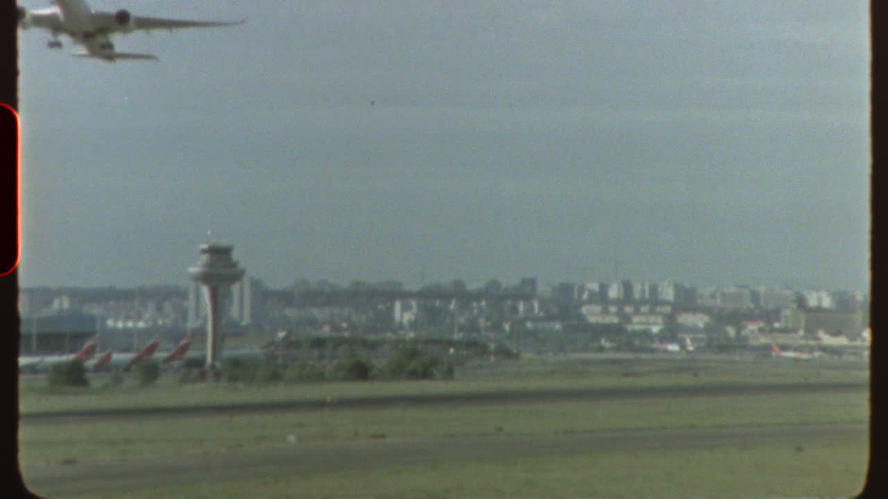 Filmed on super 8 film - airplane taking off from airport runway