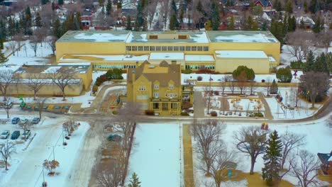 aerial winter semi circle around the quiet government house with the old royal alberta museum designated by her majesty queen elizabeth ii on may 24th 2005 in celebration of alberta's centennial 1-6