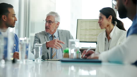 a group of medical professionals meet in a conference room to discuss business.