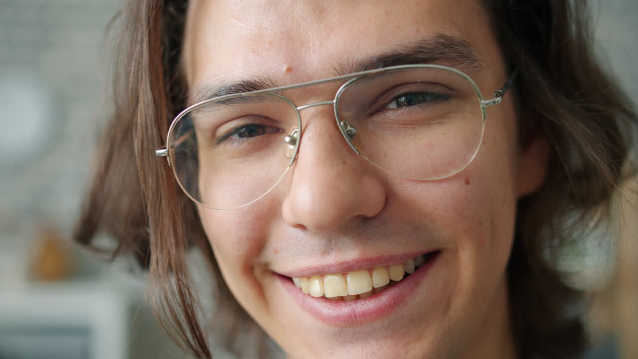 Smiling young adult with glasses