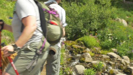 hikers travers a rocky stream