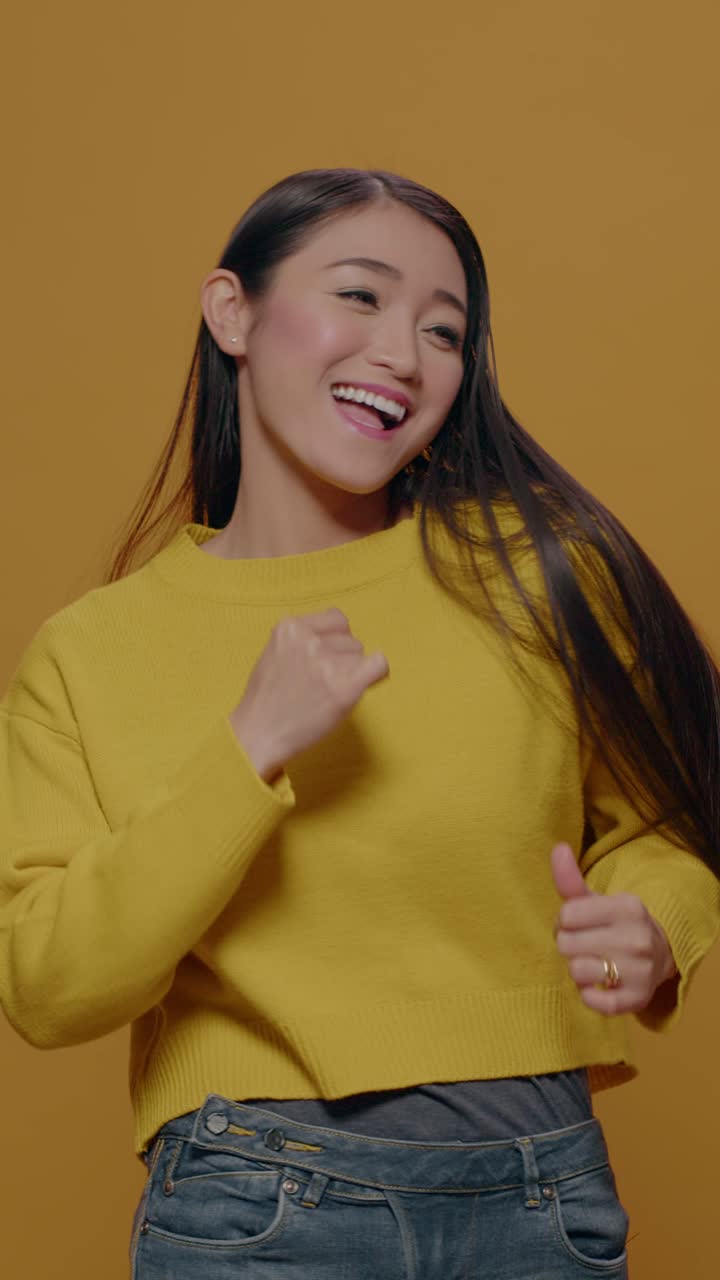 Woman Dancing in Yellow Sweater