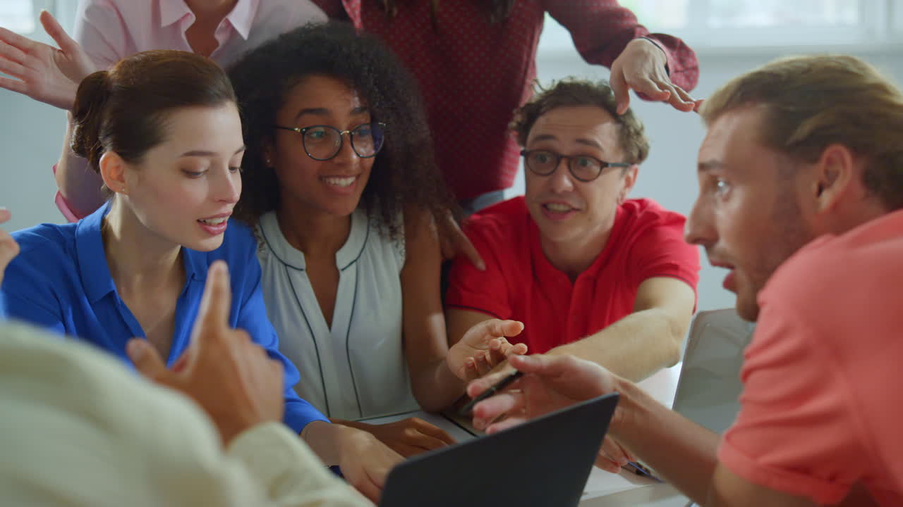 Creative team looking computer office. Successful people giving high five.
