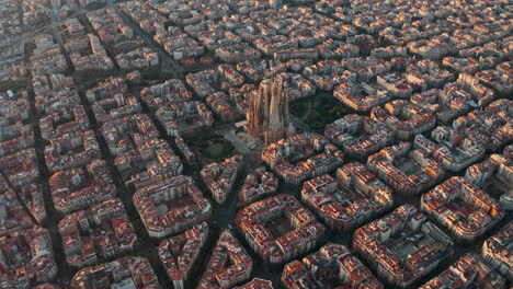 high circling drone shot of la sagrada familia church barcelona at sunrise