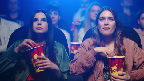 pretty girls eating in movie theater