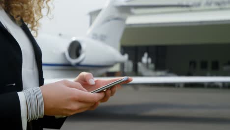 Businesswoman-using-mobile-phone-at-terminal-4k