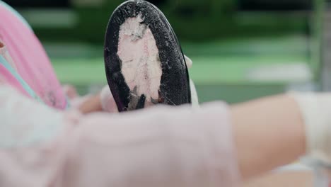 worker in a shoe factory gluing the sole of a shoe, focusing on the detailed process of assembly