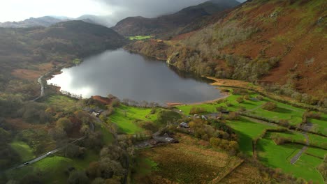 drone flying over banks of llyn gwynant in snowdonia, wales in uk