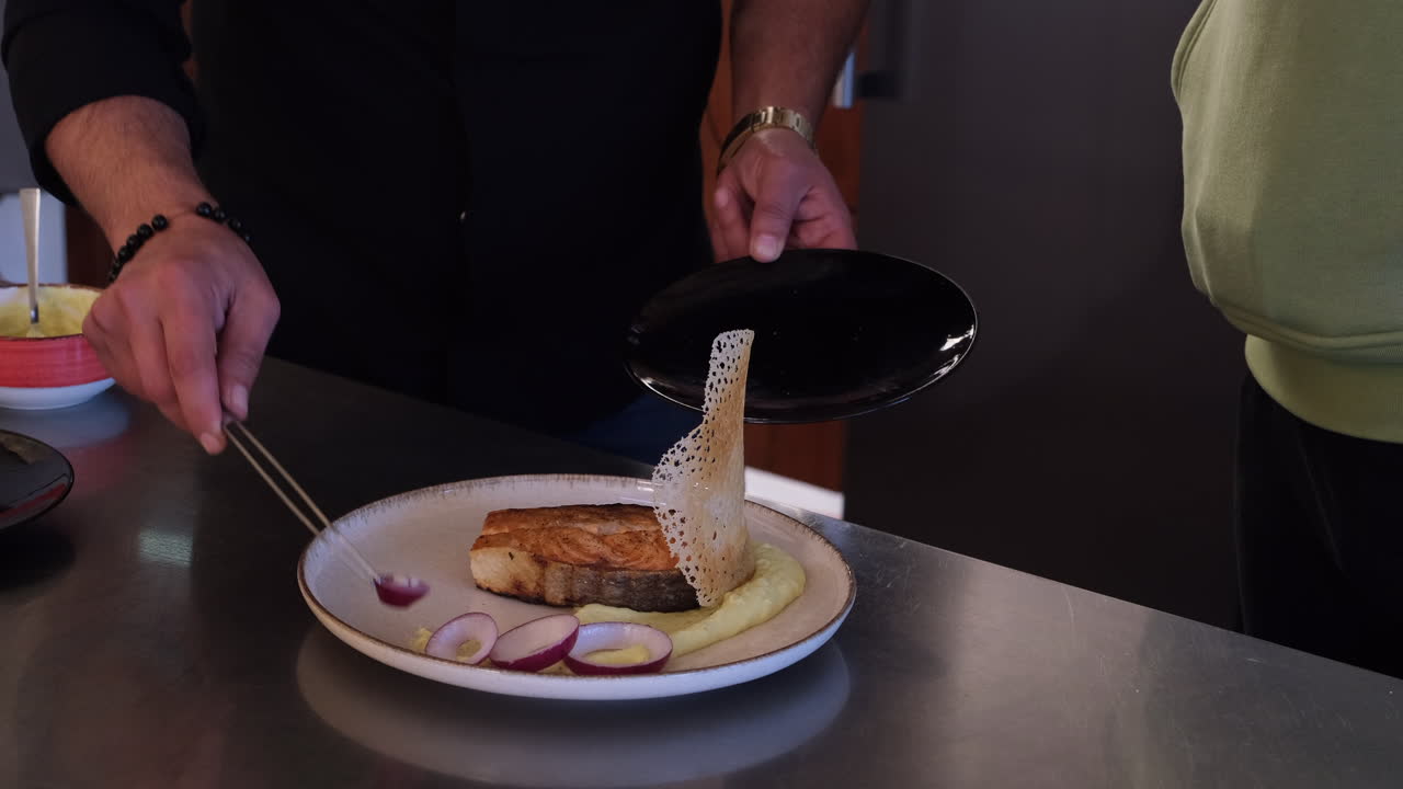Chef plating a delicious salmon dish