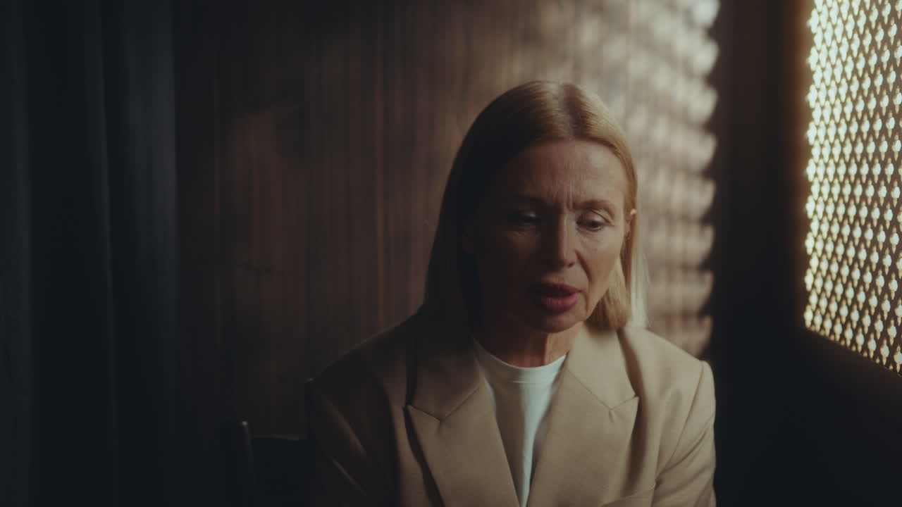 Despaired Senior Woman Crying in Confessional Booth