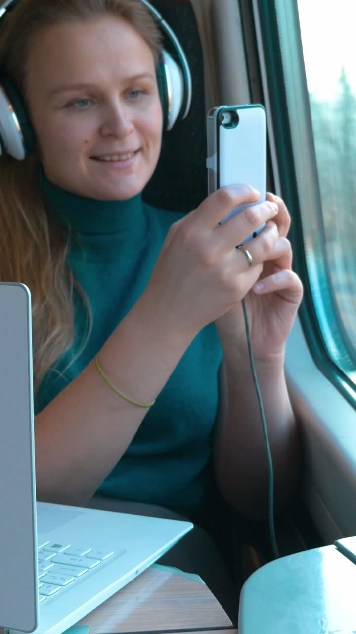 Woman Working on Laptop and Phone on Train
