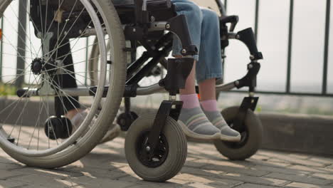 legs of girl with multiple sclerosis sitting in wheelchair