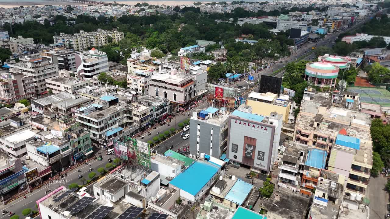 Aerial view of Vijayawada with the city's buildings clustered together and a hill adding natural charm to the horizon.