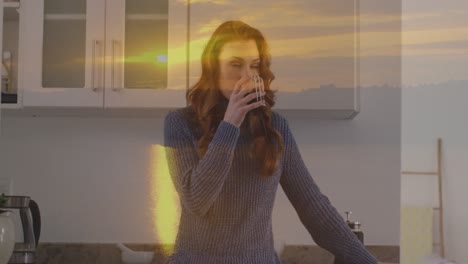 animación de paisaje de puesta de sol sobre mujer caucásica bebiendo café en la cocina