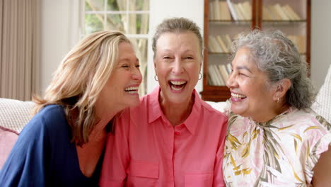 three cheerful senior women share a joyful moment together indoors