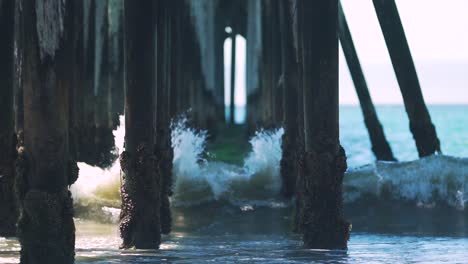 Slow-Motion-Shot-of-Waves-Breaking-and-Splashing-on-Old-Wooden-Pier