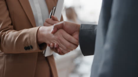 close up business people shaking hands  corporate partnership deal welcoming opportunity for cooperation in office