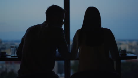 people having rest against city background. man and woman talking in open space