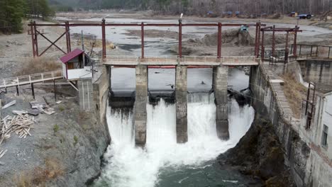 old hydroelectric power station on the chemal river in altai on a summer day aerial view from above drones aerial view from above by drones