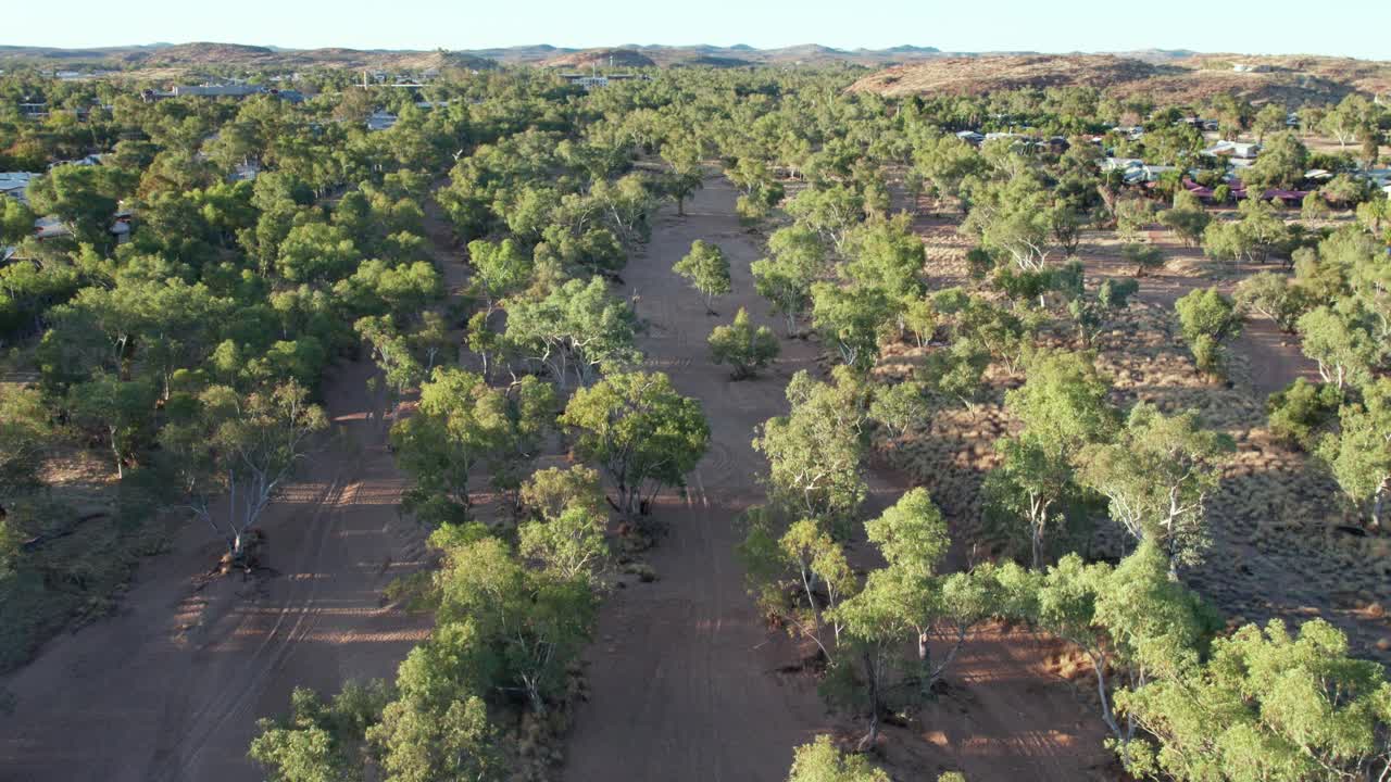 Aerial footage moving forward along the Todd RIver in the late afternoon. Alice Springs, Mparntwe, Northern Territory, Australia. August 2022.