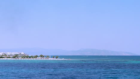 Pan-wide-view-of-port-of-Agistri-island,-Argosaronikos,-Greece,-view-from-travelling-ferry-boat