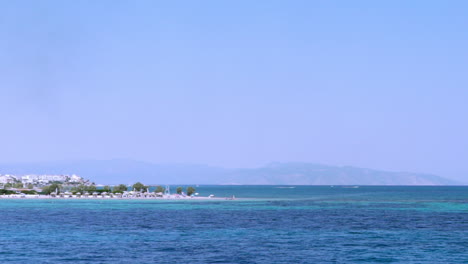 pan wide view of port of agistri island, argosaronikos, greece, view from travelling ferry boat