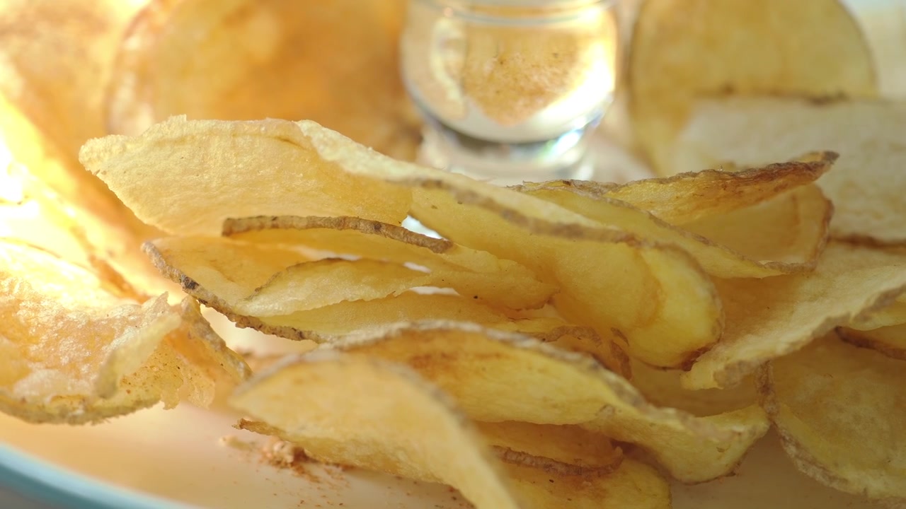 Close-up of Crispy Golden Potato Chips in a Bowl