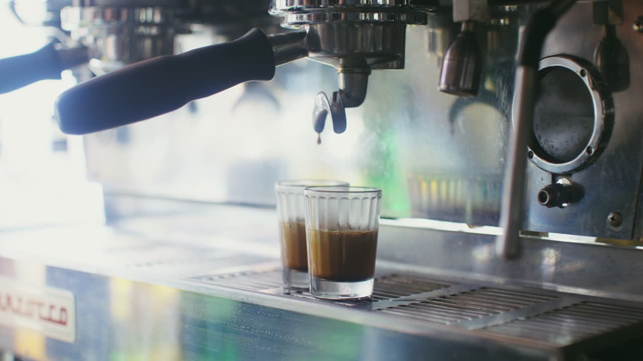 에스프레소 기계 는 커피 를 작은 컵 에 부어 놓는다