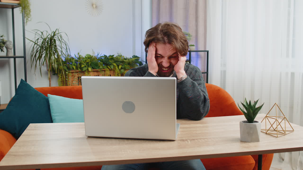 Tired caucasian man freelancer use laptop suffering from headache problem tension migraine stress