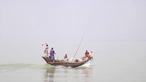 fisherman going off on trawler on river padma in bangladesh. slow motion