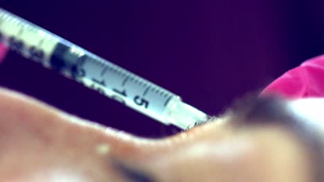 close up of a woman getting botox injections to her face