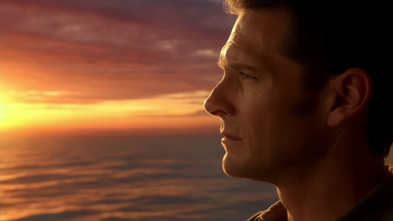 Man gazing at a beautiful sunset over the ocean