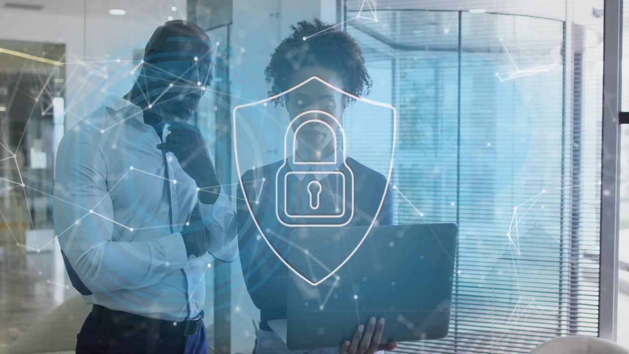 Business colleagues reviewing laptop, woman scrolling and activating shield overlay protecting data