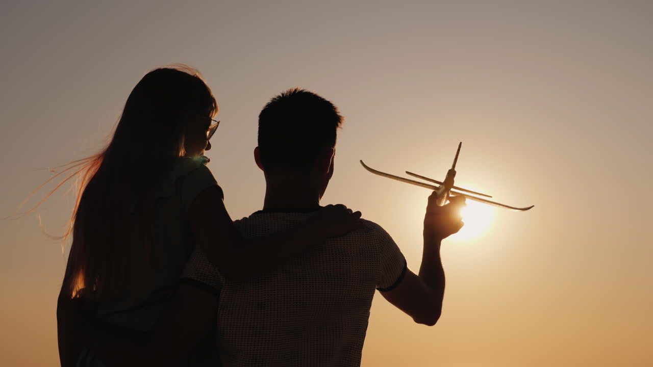 Man And Child Play With A Toy Airplane