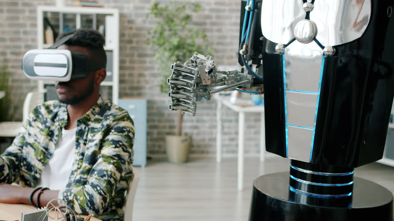Man wearing VR headset interacts with a robot arm in a laboratory setting
