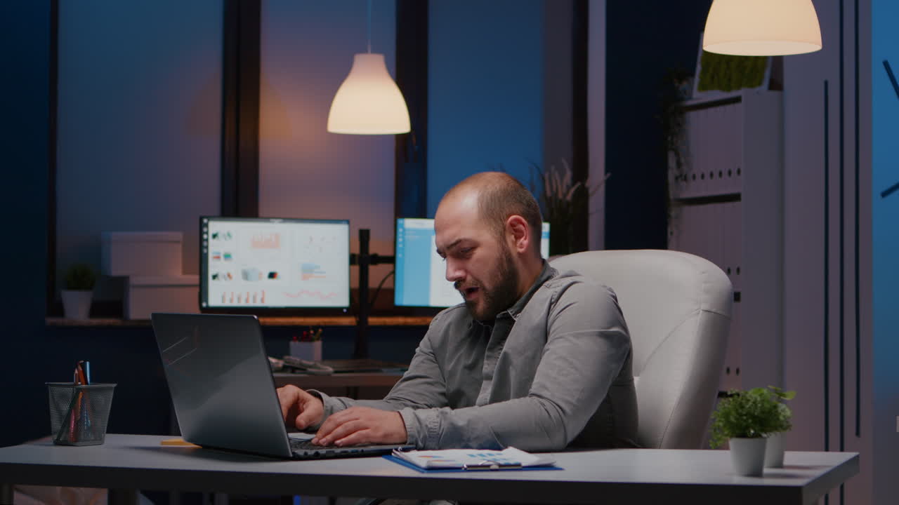 Overworked businessman typing management strategy on laptop working in startup company