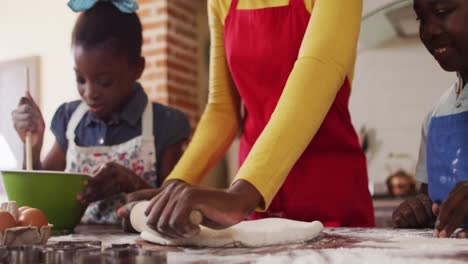 african american mother and her children in the kitchen